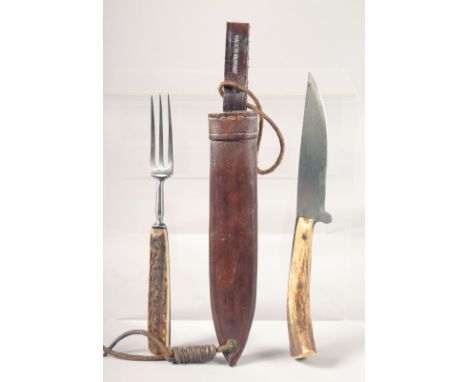 AN OLD KNIFE AND FORK, with antler handles, 8" long, in a leather case.