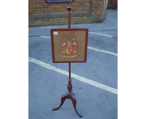 A firescreen with square tapestry panel, on pole and three legs. 119cm high.