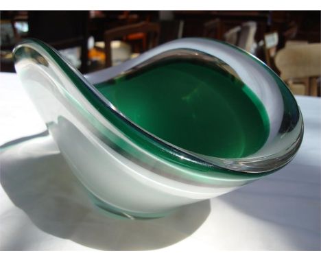 A Flygsfors glass bowl by Paul Kedelv, green glass centre within clear glass, 31cm long. 