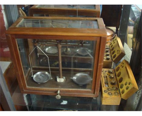 A cased set of WBN Glasgow beam scales, along with a cased set of weights.