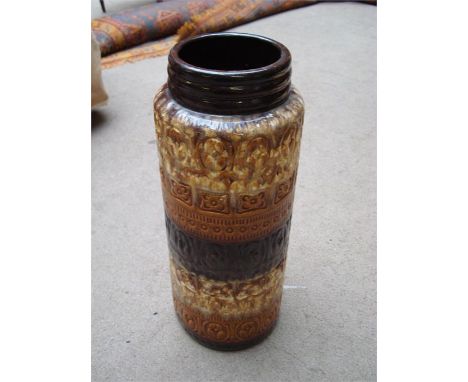 A stick stand / umbrella stand, with brown, cream and black interspearsed decoration. 