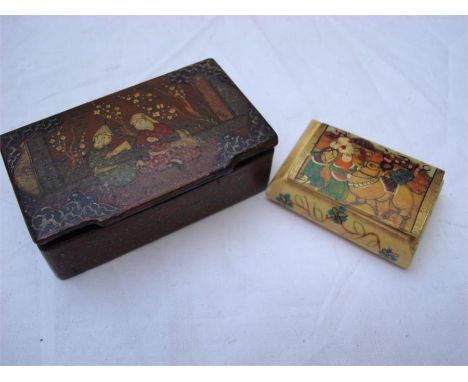 A Persian lacquered snuff box, hand painted with figures, 8.5 x 5.5cm (Made in Iran to underside) together with a poss Persia