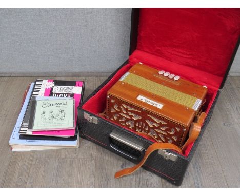 A Saltarelle La Boebe D/G melodeon, hard cased, together with booklets and music 