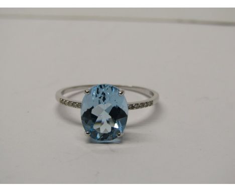 9CT WHITE GOLD BLUE TOPAZ &amp; DIAMOND RING, principal oval cut blue topaz of approximately 2ct with accent diamonds to each