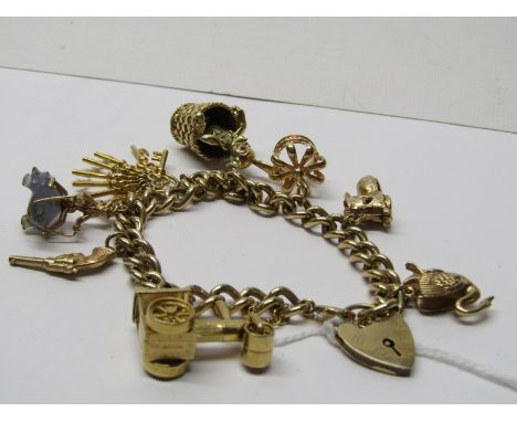 9CT YELLOW GOLD CHARM BRACELET, with charms including swan, opening boot, crown, keys, traction engine, pistol &amp; gnome ri