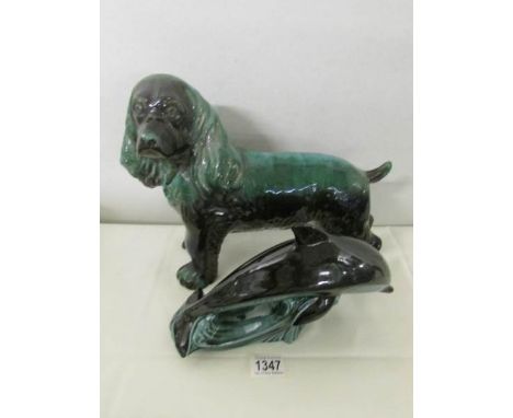 A large Blue Mountain pottery spaniel and a Poole pottery dolphin.