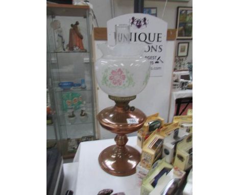 An oil lamp with shade.