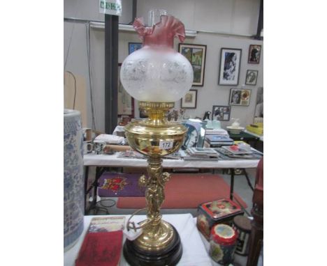 A brass cherub oil lamp with shade.