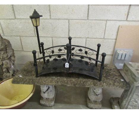 A garden bench seat and a small bridge.