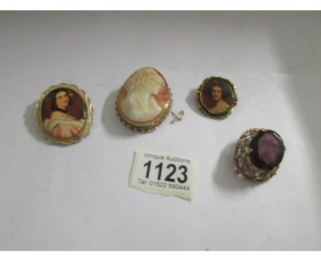 A cameo brooch, 2 portrait brooches and one other.