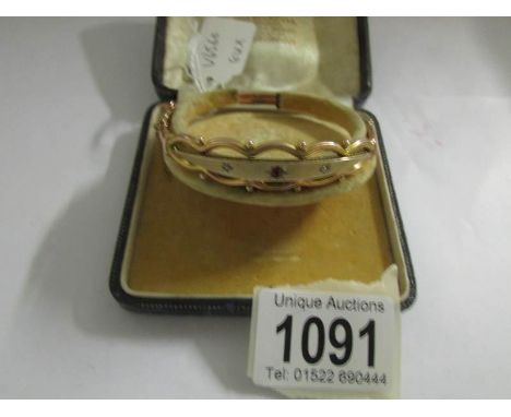 A 9ct gold bracelet set ruby and 2 diamonds.