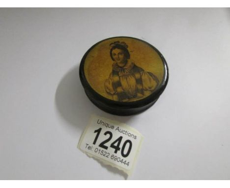 A 19th century lacquered pill box with portrait on top.
