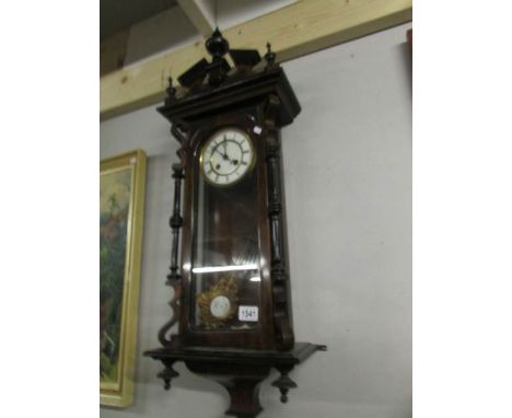 A mahogany wall clock.