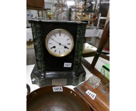 A black marble mantel clock marked Wilkins & Gandar, The Strand, Fabrique De Paris.
