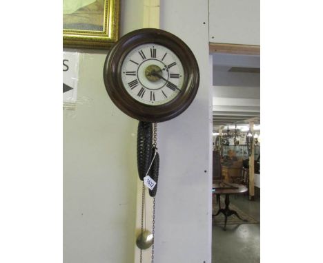 A Victorian postman's alarm clock with pendulum and 2 weights.