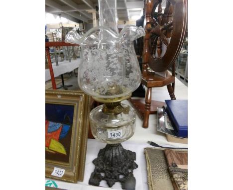 A brass oil lamp with later shade.
