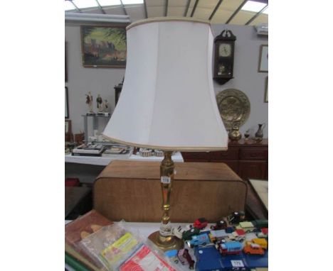 A brass table lamp with shade.