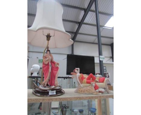 A Coalport 'roaring Twenties' table lamp and reclining lady on couch.