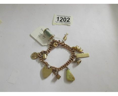 A gold charm bracelet with charms, approximately 38 grams.