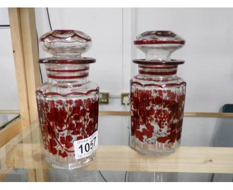 A pair of ruby flashed cut glass pickle jars.