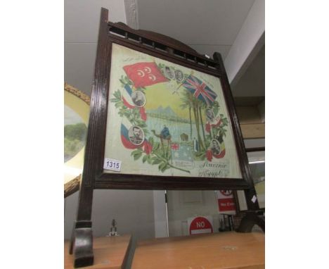 An oak firescreen inset souvenir of Egypt silk panel.