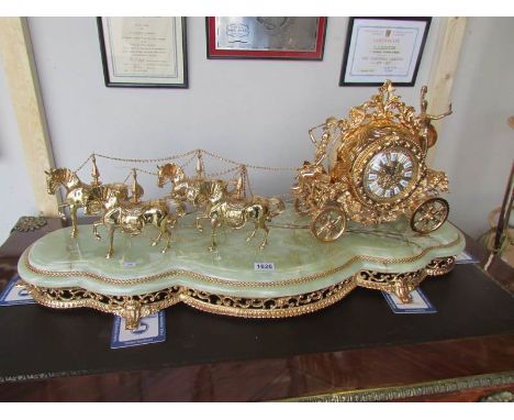 A large fabulous gilded brass coach and horses clock with quartz movement,.