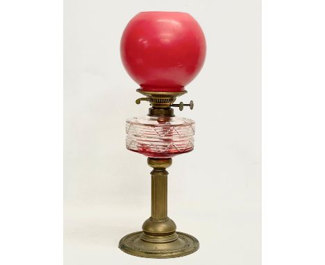 A late Victorian brass double burner oil lamp, with later shade. 1900. 53cm 