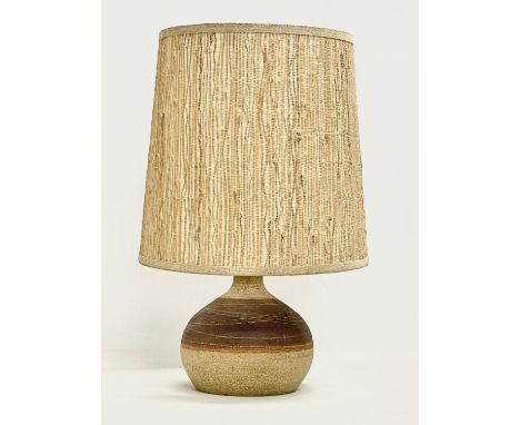 A 1960’s Mid Century stoneware table lamp with original shade. Base measures 17x18cm. Shade measures 30x30cm 