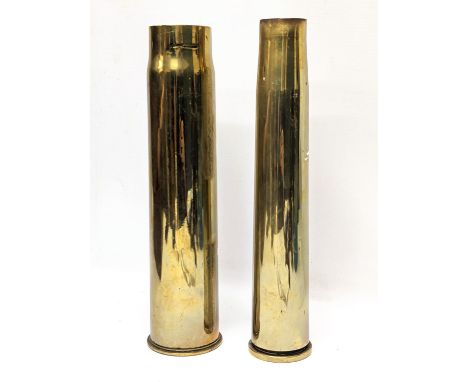 A World War I brass Trench Art shell marked 1917, with World War II brass shell, marked 1942. Tallest 31cm 