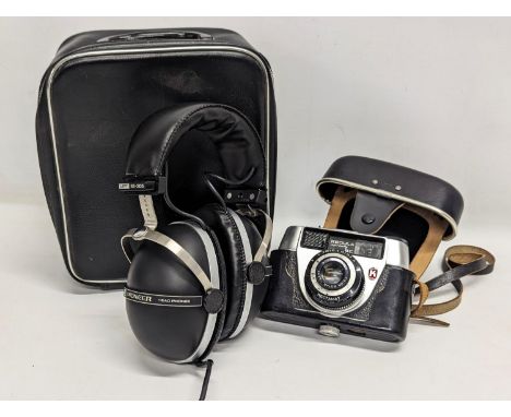 A pair of vintage Pioneer SE-305 Headphones in case with a Regula camera 