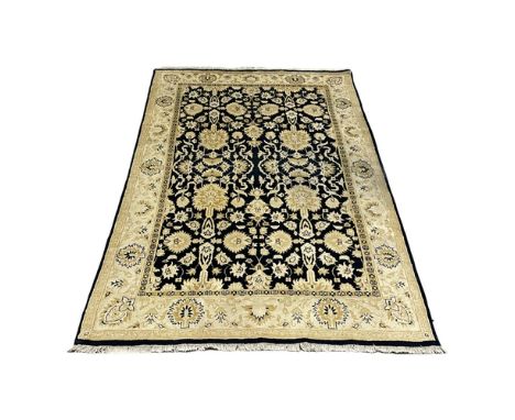 A large vintage hand knotted rug. 182x287cm