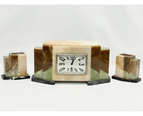 A 1930’ Art Deco slate clock set by Marti Jours. Clock measures 42x11x21cm. Garnitures measure 14x8x13.5cm each 