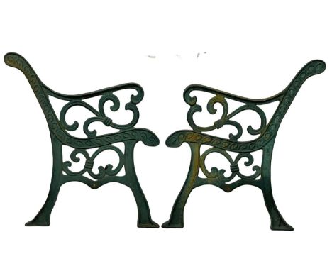 A pair of large cast iron garden bench ends. 71x77cm 