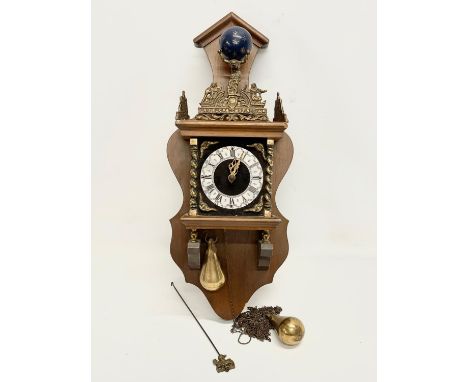 A vintage Dutch wall clock. Weights and pendulum. 