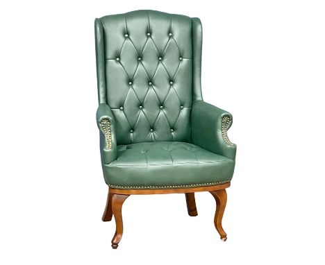 A faux leather deep button wingback armchair. 