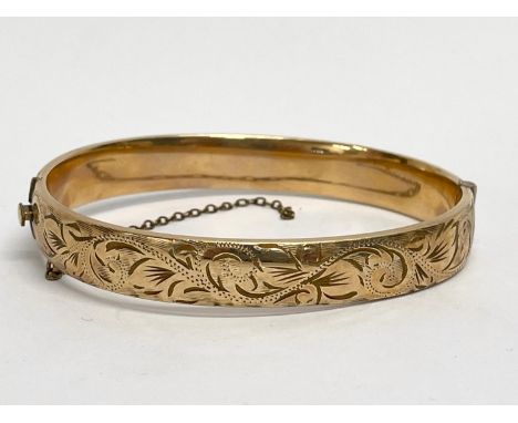 A rolled gold bangle. 