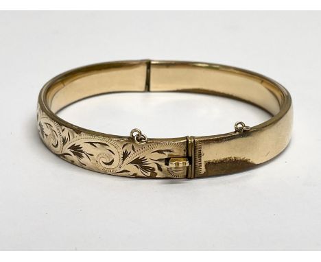 A rolled gold bangle. 