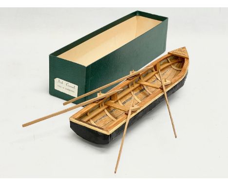An Irish hand made Currach model in box. Made in Connemara. Boat measures 31cm. 
