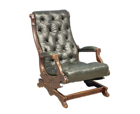 A Victorian deep button leather rocking chair. Circa 1890. 