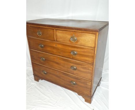 A 19th Century mahogany chest of two short and three long drawers with brass ring handles on bracket feet