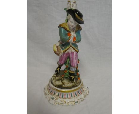 A German porcelain candlestick in the form of a young boy with rabbit on circular base 11" high