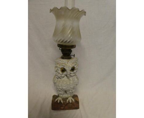 A Continental china oil lamp in the form of an owl with brass mounts and frosted glass shade, 23" high overall