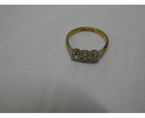 An 18ct gold dress ring with platinum shoulders set three small diamonds