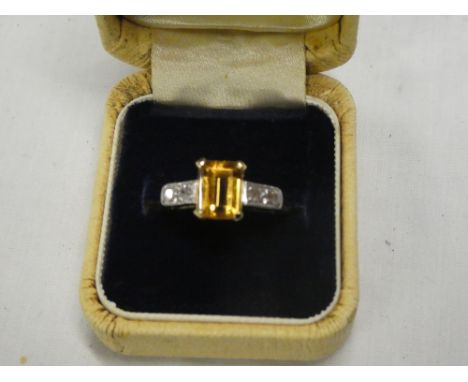 An 18ct gold dress ring set rectangular yellow topaz flanked by four small diamonds