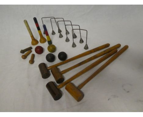 An old table croquet game including four mallets, four balls, hoops, etc