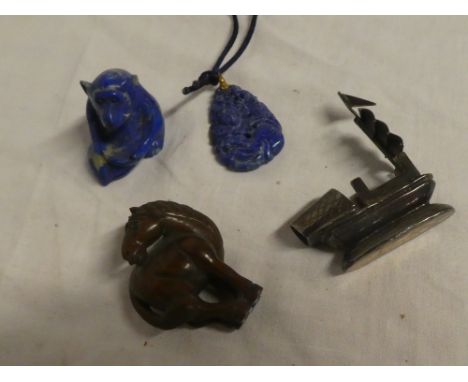 A Japanese carved wood netsuke in the form of a horse, Eastern blue jade pendant, soapstone monkey and a small silvered boat 