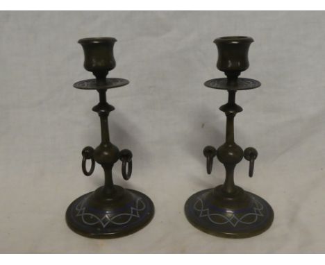 A pair of enamelled bronze tapered candlesticks with ring decoration on circular bases, 6½" high 