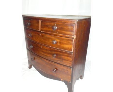 A Victorian mahogany bow front chest of two short and three long drawers with turned handles on bracket feet