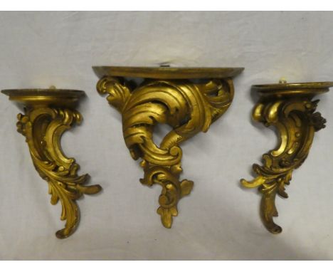 A pair of gilt painted wood scroll wall brackets and one other similar wall bracket decorated in relief with leaves (3)