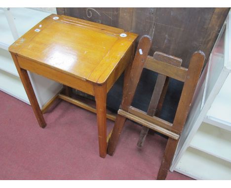 A Childs Pitch Pine School Desk, with twin inkwells, hinged sloping tops on chamferred supports united by 'H stretcher; toget